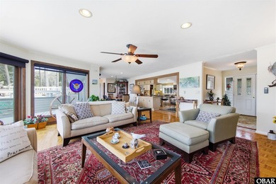 This single-story creek-side home aligns with the surrounding on Duck Woods Country Club in North Carolina - for sale on GolfHomes.com, golf home, golf lot