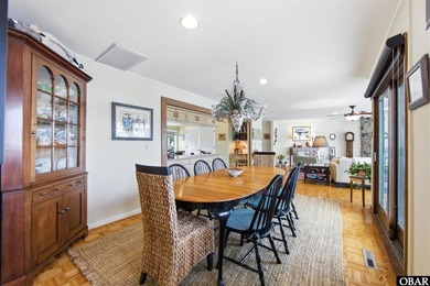 This single-story creek-side home aligns with the surrounding on Duck Woods Country Club in North Carolina - for sale on GolfHomes.com, golf home, golf lot