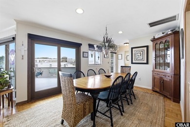 This single-story creek-side home aligns with the surrounding on Duck Woods Country Club in North Carolina - for sale on GolfHomes.com, golf home, golf lot