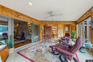 This single-story creek-side home aligns with the surrounding on Duck Woods Country Club in North Carolina - for sale on GolfHomes.com, golf home, golf lot