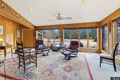 This single-story creek-side home aligns with the surrounding on Duck Woods Country Club in North Carolina - for sale on GolfHomes.com, golf home, golf lot