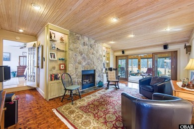 This single-story creek-side home aligns with the surrounding on Duck Woods Country Club in North Carolina - for sale on GolfHomes.com, golf home, golf lot