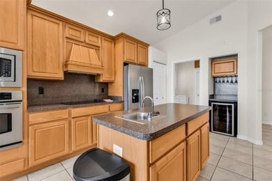 Experience the Florida lifestyle at its finest in this on Kings Gate Golf Club in Florida - for sale on GolfHomes.com, golf home, golf lot