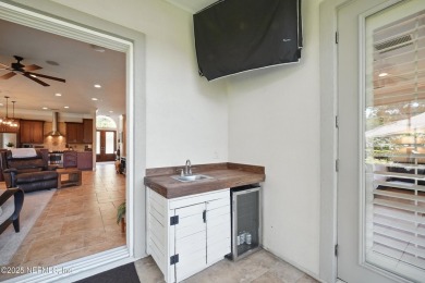 Nestled beneath a canopy of mature oak trees in the gated on Queens Harbour Yacht and Country Club in Florida - for sale on GolfHomes.com, golf home, golf lot
