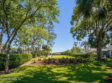 Nestled beneath a canopy of mature oak trees in the gated on Queens Harbour Yacht and Country Club in Florida - for sale on GolfHomes.com, golf home, golf lot