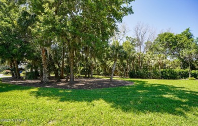 Nestled beneath a canopy of mature oak trees in the gated on Queens Harbour Yacht and Country Club in Florida - for sale on GolfHomes.com, golf home, golf lot