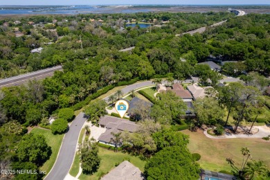 Nestled beneath a canopy of mature oak trees in the gated on Queens Harbour Yacht and Country Club in Florida - for sale on GolfHomes.com, golf home, golf lot