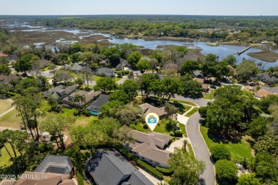Nestled beneath a canopy of mature oak trees in the gated on Queens Harbour Yacht and Country Club in Florida - for sale on GolfHomes.com, golf home, golf lot