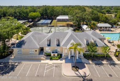 Nestled beneath a canopy of mature oak trees in the gated on Queens Harbour Yacht and Country Club in Florida - for sale on GolfHomes.com, golf home, golf lot