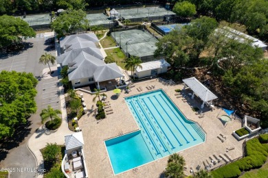 Nestled beneath a canopy of mature oak trees in the gated on Queens Harbour Yacht and Country Club in Florida - for sale on GolfHomes.com, golf home, golf lot