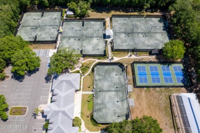 Nestled beneath a canopy of mature oak trees in the gated on Queens Harbour Yacht and Country Club in Florida - for sale on GolfHomes.com, golf home, golf lot