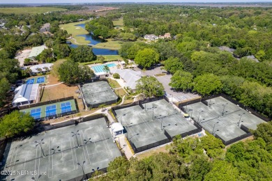 Nestled beneath a canopy of mature oak trees in the gated on Queens Harbour Yacht and Country Club in Florida - for sale on GolfHomes.com, golf home, golf lot