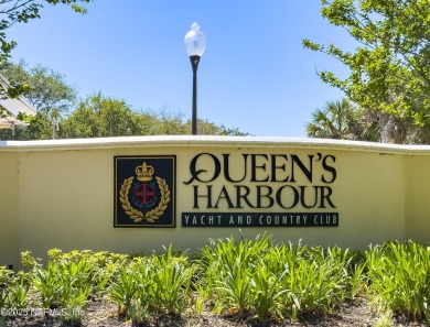 Nestled beneath a canopy of mature oak trees in the gated on Queens Harbour Yacht and Country Club in Florida - for sale on GolfHomes.com, golf home, golf lot