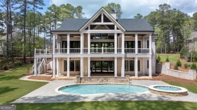 Indulge in opulent living within this custom 5-bedroom, 5.5-bath on Reynolds Lake Oconee - The Oconee in Georgia - for sale on GolfHomes.com, golf home, golf lot