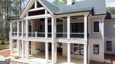 Indulge in opulent living within this custom 5-bedroom, 5.5-bath on Reynolds Lake Oconee - The Oconee in Georgia - for sale on GolfHomes.com, golf home, golf lot