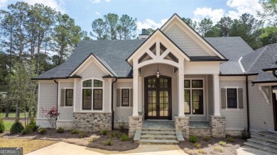 Indulge in opulent living within this custom 5-bedroom, 5.5-bath on Reynolds Lake Oconee - The Oconee in Georgia - for sale on GolfHomes.com, golf home, golf lot