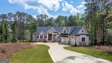 Indulge in opulent living within this custom 5-bedroom, 5.5-bath on Reynolds Lake Oconee - The Oconee in Georgia - for sale on GolfHomes.com, golf home, golf lot