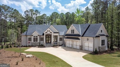 Indulge in opulent living within this custom 5-bedroom, 5.5-bath on Reynolds Lake Oconee - The Oconee in Georgia - for sale on GolfHomes.com, golf home, golf lot