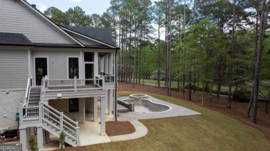 Indulge in opulent living within this custom 5-bedroom, 5.5-bath on Reynolds Lake Oconee - The Oconee in Georgia - for sale on GolfHomes.com, golf home, golf lot