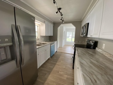 Lovely remodeled home with new kitchen, flooring, roof and on Spanish Lakes Golf Village in Florida - for sale on GolfHomes.com, golf home, golf lot