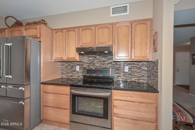 This charming 2 bedroom, 2 bath home has a bright living room on Sun City Lakes West and East in Arizona - for sale on GolfHomes.com, golf home, golf lot