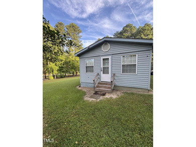 Escape to Lake Royale with this unique weekend retreat at 106 & on River Golf and Country Club at Lake Royale in North Carolina - for sale on GolfHomes.com, golf home, golf lot