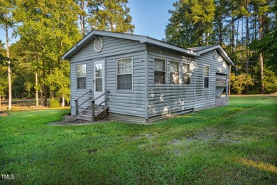 Escape to Lake Royale with this unique weekend retreat at 106 & on River Golf and Country Club at Lake Royale in North Carolina - for sale on GolfHomes.com, golf home, golf lot