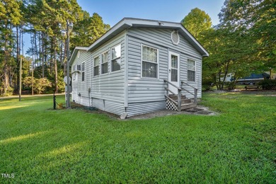Escape to Lake Royale with this unique weekend retreat at 106 & on River Golf and Country Club at Lake Royale in North Carolina - for sale on GolfHomes.com, golf home, golf lot