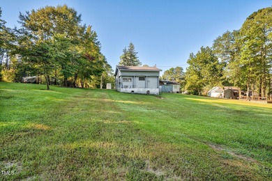 Escape to Lake Royale with this unique weekend retreat at 106 & on River Golf and Country Club at Lake Royale in North Carolina - for sale on GolfHomes.com, golf home, golf lot