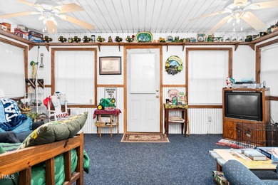 Escape to Lake Royale with this unique weekend retreat at 106 & on River Golf and Country Club at Lake Royale in North Carolina - for sale on GolfHomes.com, golf home, golf lot