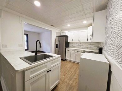 Nestled close to Dogwood Golf Course, this lovely end unit on Bella Vista Country Club and Golf Course in Arkansas - for sale on GolfHomes.com, golf home, golf lot