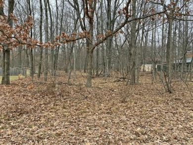 This buildable wooded lot in Canadian Lakes comes with a 35ft on Canadian Lakes Country Club-The Highlands Course in Michigan - for sale on GolfHomes.com, golf home, golf lot