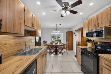 Beautiful one-story villa located in a desirable 24-hour manned on Cypress Lakes Golf Course - West Palm Beach in Florida - for sale on GolfHomes.com, golf home, golf lot