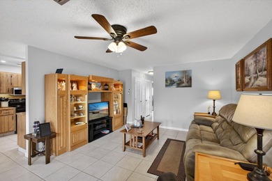 Beautiful one-story villa located in a desirable 24-hour manned on Cypress Lakes Golf Course - West Palm Beach in Florida - for sale on GolfHomes.com, golf home, golf lot