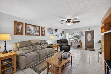 Beautiful one-story villa located in a desirable 24-hour manned on Cypress Lakes Golf Course - West Palm Beach in Florida - for sale on GolfHomes.com, golf home, golf lot