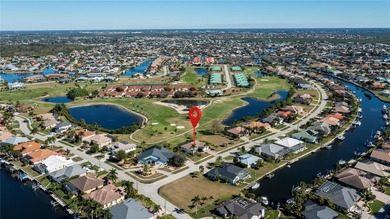 STUNNING MANICURED GOLF COURSE and TRANQUIL LAKE VIEWS await you on Saint Andrews South Golf Club in Florida - for sale on GolfHomes.com, golf home, golf lot
