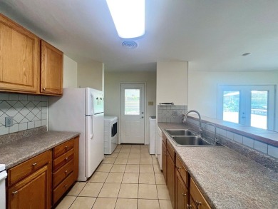 Nicely updated 3/2 brick home perched high for stunning views on Scott Schriener Municipal Golf Course in Texas - for sale on GolfHomes.com, golf home, golf lot