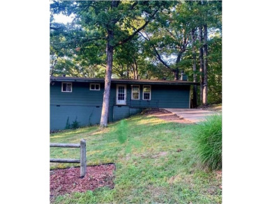 This 2-bedroom, 1-bath home has two lots totalling .75-acre lot on Bella Vista - Metfield Golf Complex and Country Club in Arkansas - for sale on GolfHomes.com, golf home, golf lot
