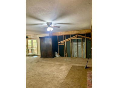 This 2-bedroom, 1-bath home has two lots totalling .75-acre lot on Bella Vista - Metfield Golf Complex and Country Club in Arkansas - for sale on GolfHomes.com, golf home, golf lot