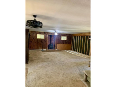 This 2-bedroom, 1-bath home has two lots totalling .75-acre lot on Bella Vista - Metfield Golf Complex and Country Club in Arkansas - for sale on GolfHomes.com, golf home, golf lot