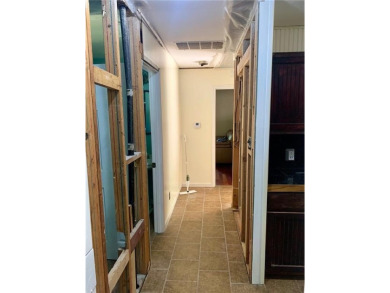 This 2-bedroom, 1-bath home has two lots totalling .75-acre lot on Bella Vista - Metfield Golf Complex and Country Club in Arkansas - for sale on GolfHomes.com, golf home, golf lot