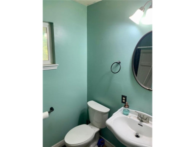 This 2-bedroom, 1-bath home has two lots totalling .75-acre lot on Bella Vista - Metfield Golf Complex and Country Club in Arkansas - for sale on GolfHomes.com, golf home, golf lot