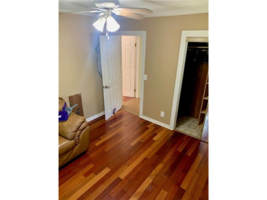 This 2-bedroom, 1-bath home has two lots totalling .75-acre lot on Bella Vista - Metfield Golf Complex and Country Club in Arkansas - for sale on GolfHomes.com, golf home, golf lot