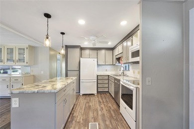 Enjoy relaxed Florida living in this 1978 home nestled inside a on Maple Leaf Golf and Country Club in Florida - for sale on GolfHomes.com, golf home, golf lot