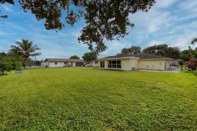 ESTATE SALE 3/2 2 CAR GARAGE, ON THE GOLF COURSE VACANT SOLD AS on Palm Beach National Golf and Country Club in Florida - for sale on GolfHomes.com, golf home, golf lot