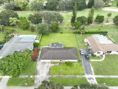 ESTATE SALE 3/2 2 CAR GARAGE, ON THE GOLF COURSE VACANT SOLD AS on Palm Beach National Golf and Country Club in Florida - for sale on GolfHomes.com, golf home, golf lot