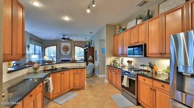 Warm and inviting 4 BR pool home with lake and fountain view on Plantation Bay Golf and Country Club in Florida - for sale on GolfHomes.com, golf home, golf lot