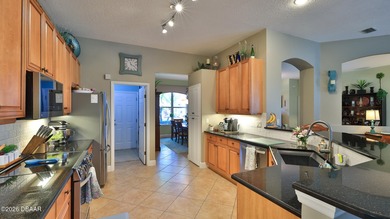 Warm and inviting 4 BR pool home with lake and fountain view on Plantation Bay Golf and Country Club in Florida - for sale on GolfHomes.com, golf home, golf lot