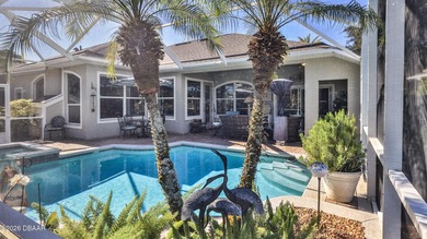 Warm and inviting 4 BR pool home with lake and fountain view on Plantation Bay Golf and Country Club in Florida - for sale on GolfHomes.com, golf home, golf lot