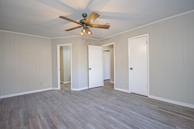 This older home has been renovated .   It has new flooring on Neches Pines Golf Course in Texas - for sale on GolfHomes.com, golf home, golf lot